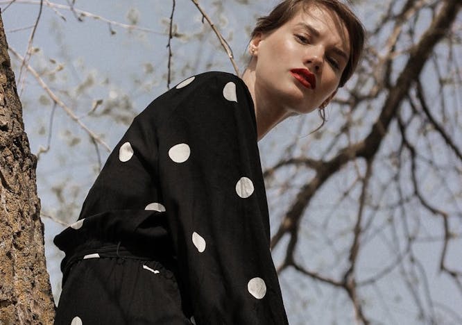 texture polka dot person human overcoat clothing coat apparel