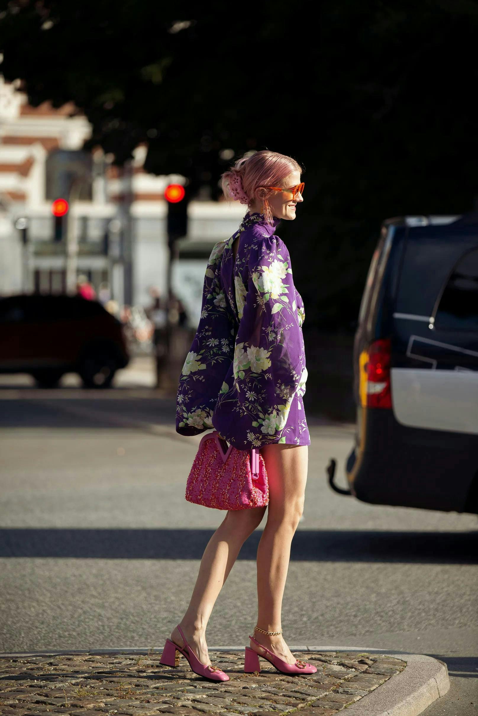 clothing person car transportation vehicle female shorts tire tarmac skirt